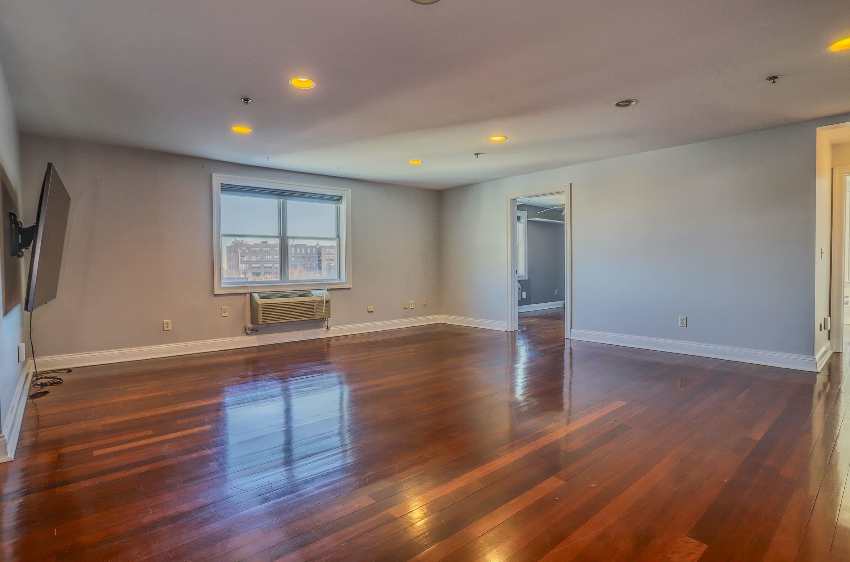1720 New York Avenue, Unit 406 Union City, NJ 07087 - Photo 5 of 21 a view of a room with wooden floor and a window