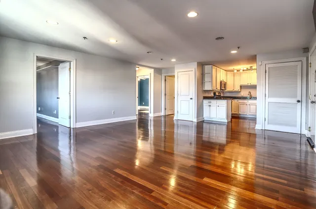 a open kitchen with white cabinets and stainless steel appliances