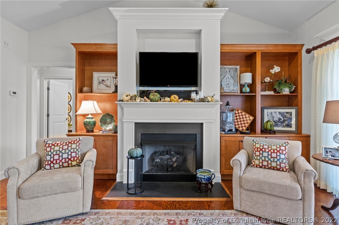 1570 Valley View Road Southern Pines, NC 28387 - Photo 14 of 44 a living room with a fireplace and a flat screen tv