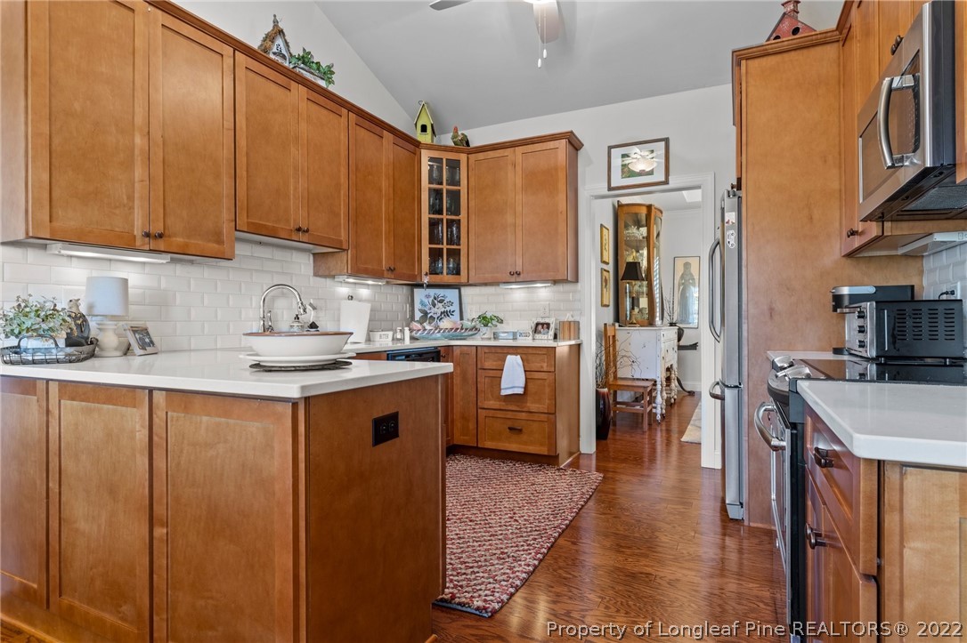 1570 Valley View Road Southern Pines, NC 28387 - Photo 15 of 44 a kitchen with stainless steel appliances granite countertop a sink a stove and a refrigerator