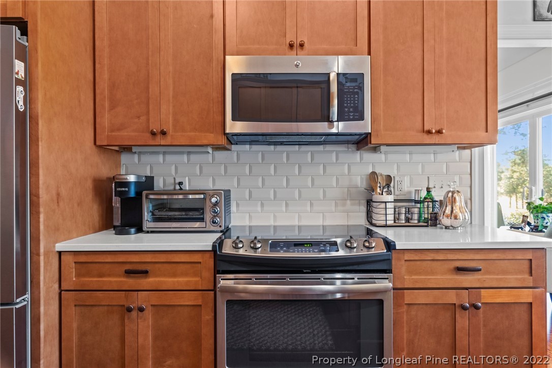 1570 Valley View Road Southern Pines, NC 28387 - Photo 18 of 44 a kitchen with stainless steel appliances granite countertop a stove microwave and cabinets