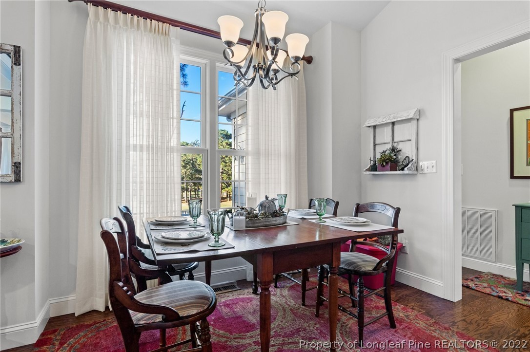 1570 Valley View Road Southern Pines, NC 28387 - Photo 20 of 44 a view of a dining room with furniture window and wooden floor