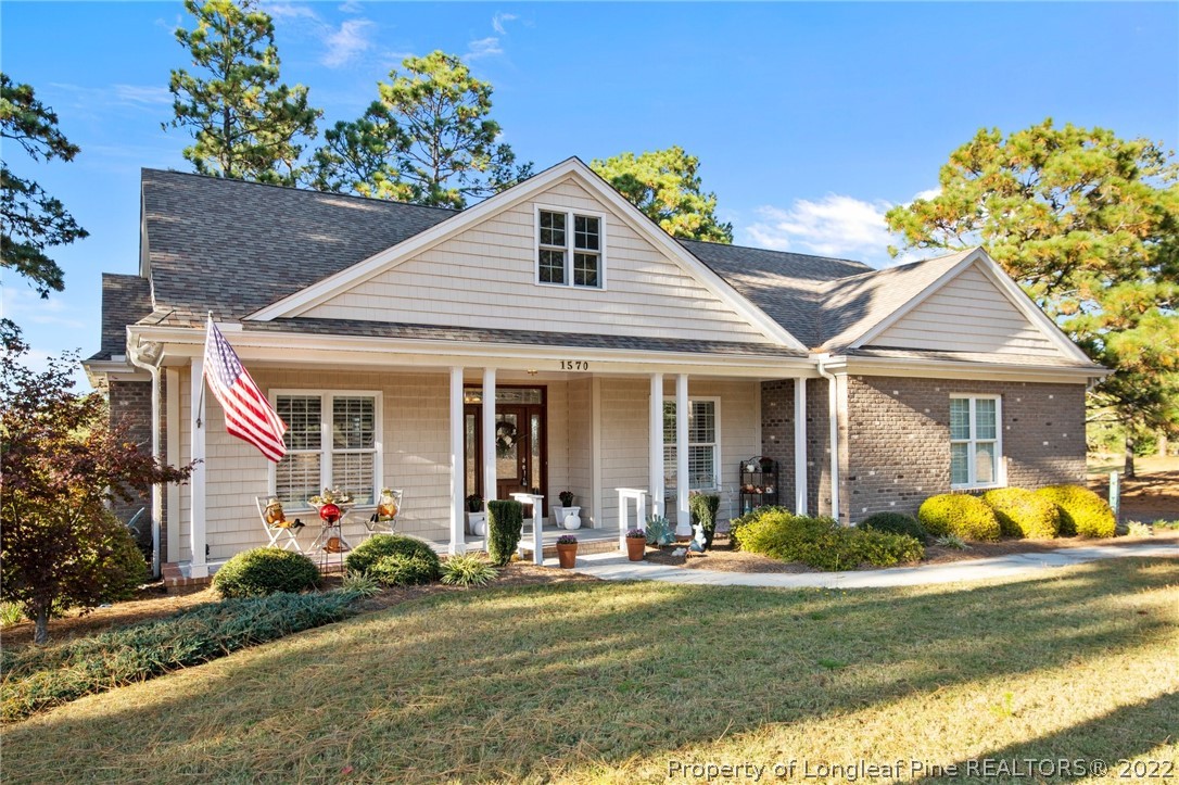 1570 Valley View Road Southern Pines, NC 28387 - Photo 2 of 44 a front view of a house with garden and plants