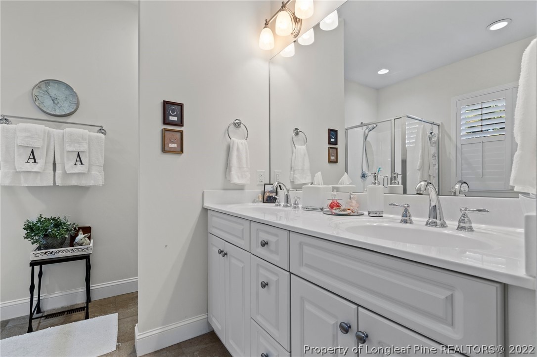 1570 Valley View Road Southern Pines, NC 28387 - Photo 25 of 44 a bathroom with a double vanity sink and a mirror