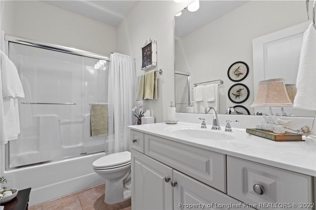 1570 Valley View Road Southern Pines, NC 28387 - Photo 32 of 44 a bathroom with a granite countertop sink mirror vanity and toilet