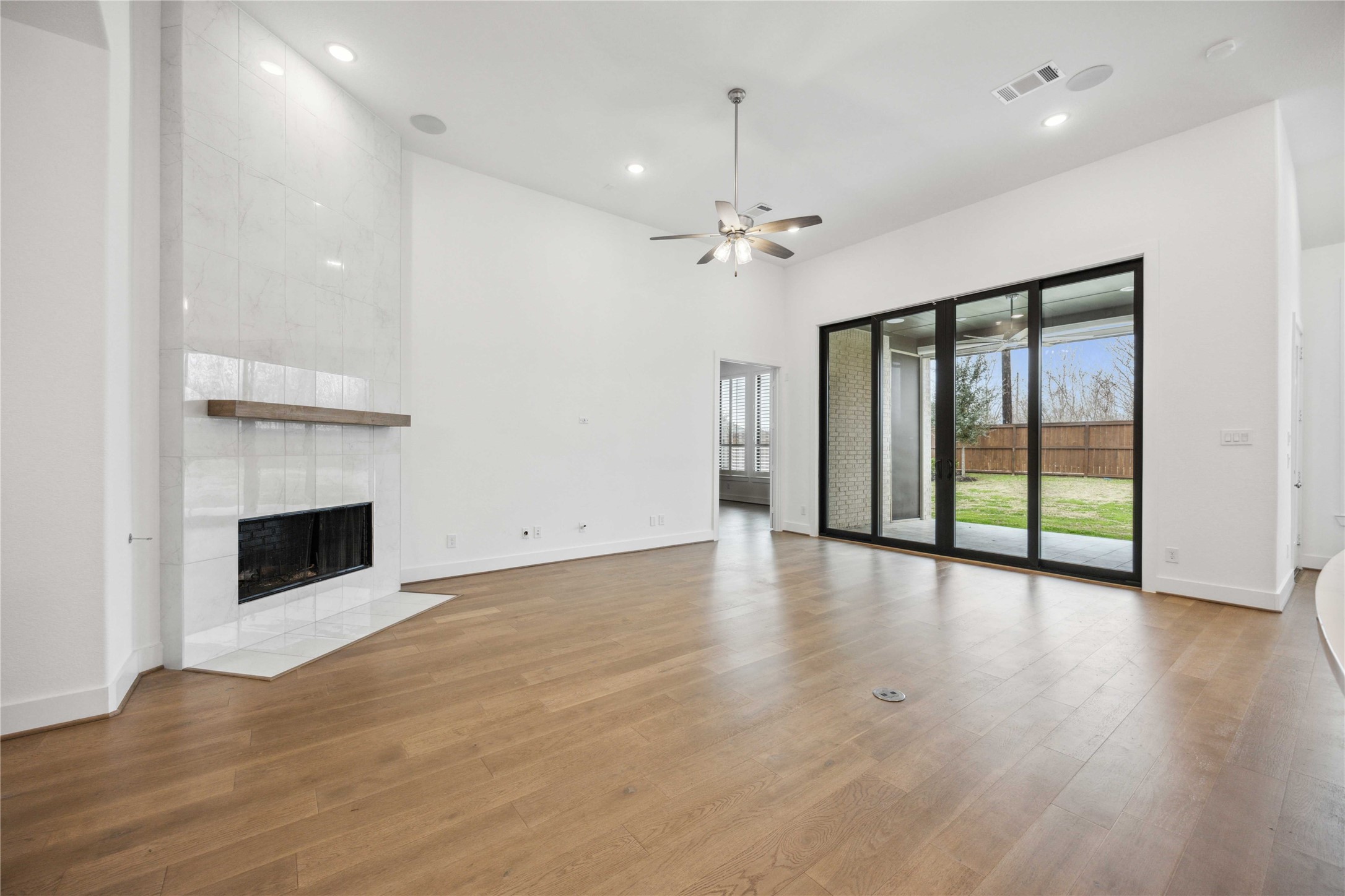2711 Merlin Way Katy, TX 77493 - Photo 24 of 50 Bright and airy living room with fireplace and slider access to the covered patio.