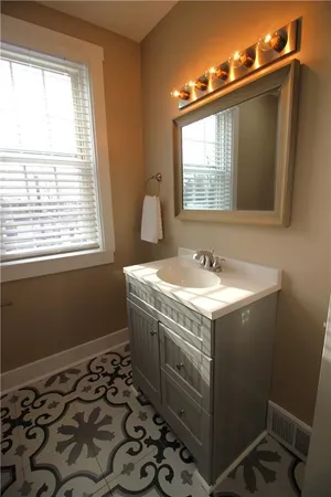 a bathroom with a sink toilet and mirror