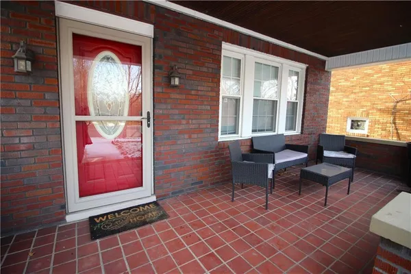 a outdoor living room with furniture and a window