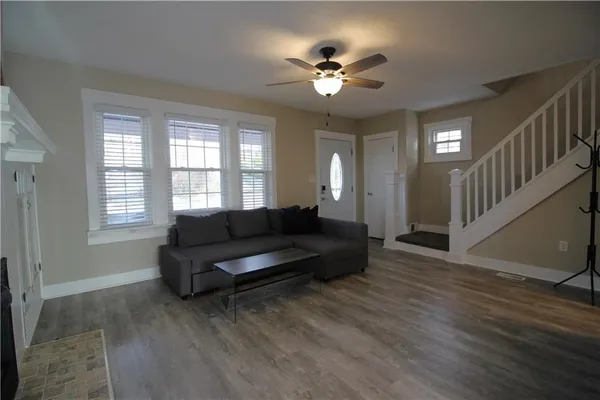 a living room with furniture and a chandelier