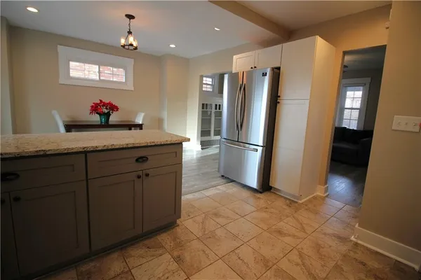 a kitchen with stainless steel appliances granite countertop a refrigerator and a sink