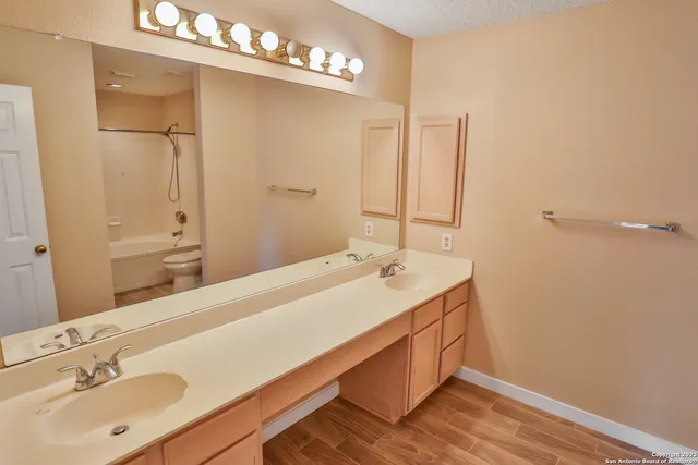 a bathroom with a sink a mirror and a shower