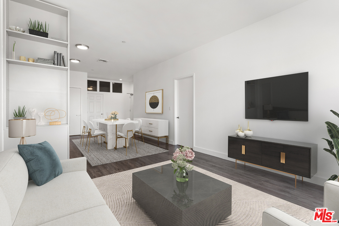 3810 Wilshire Boulevard, Unit 1408 Los Angeles, CA 90010 - Photo 1 of 34 a living room with furniture and a flat screen tv