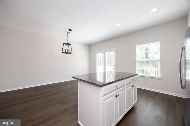 a kitchen with granite countertop a sink and a window