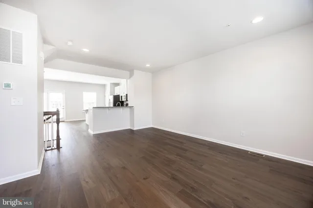 a view of a kitchen with wooden floor and a kitchen