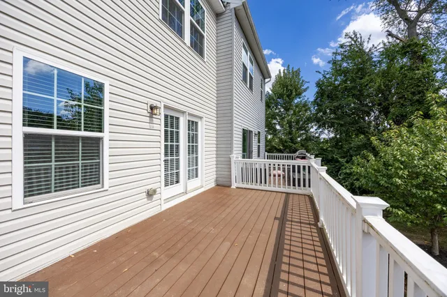 a view of balcony with wooden floor and fence