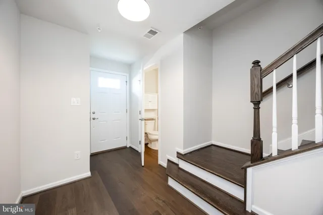 a view of front door with wooden floor