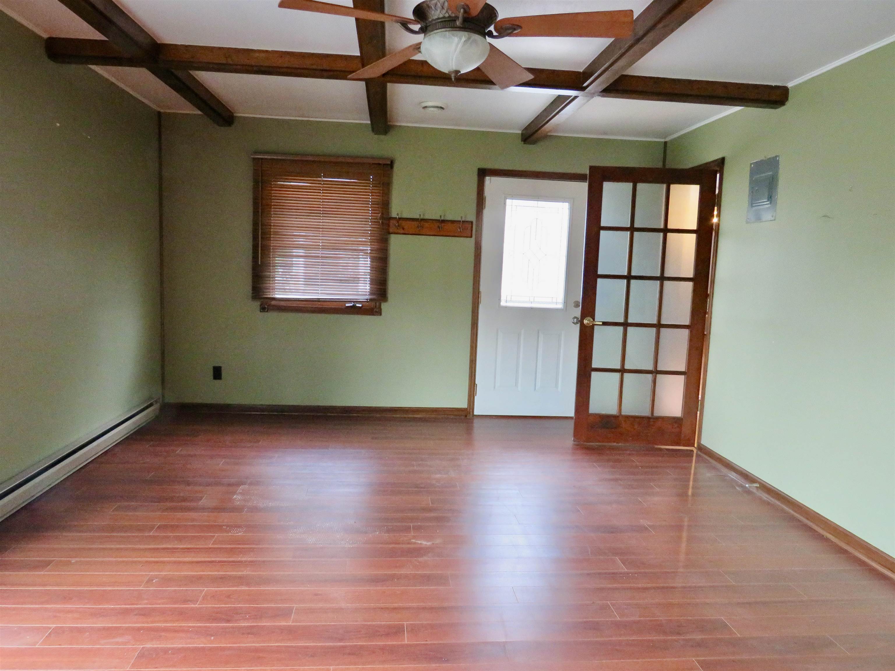1139 Highway 20 Elizabeth, IL 61028 - Photo 23 of 88 a view of an empty room with wooden floor and a window