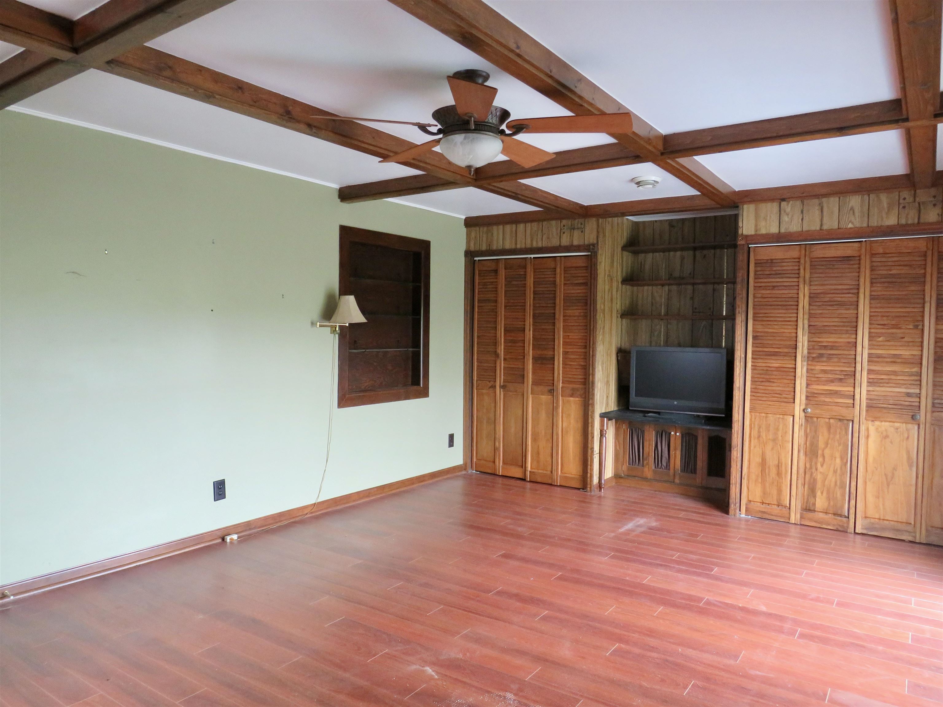 1139 Highway 20 Elizabeth, IL 61028 - Photo 24 of 88 a view of a livingroom with wooden floor and a ceiling fan