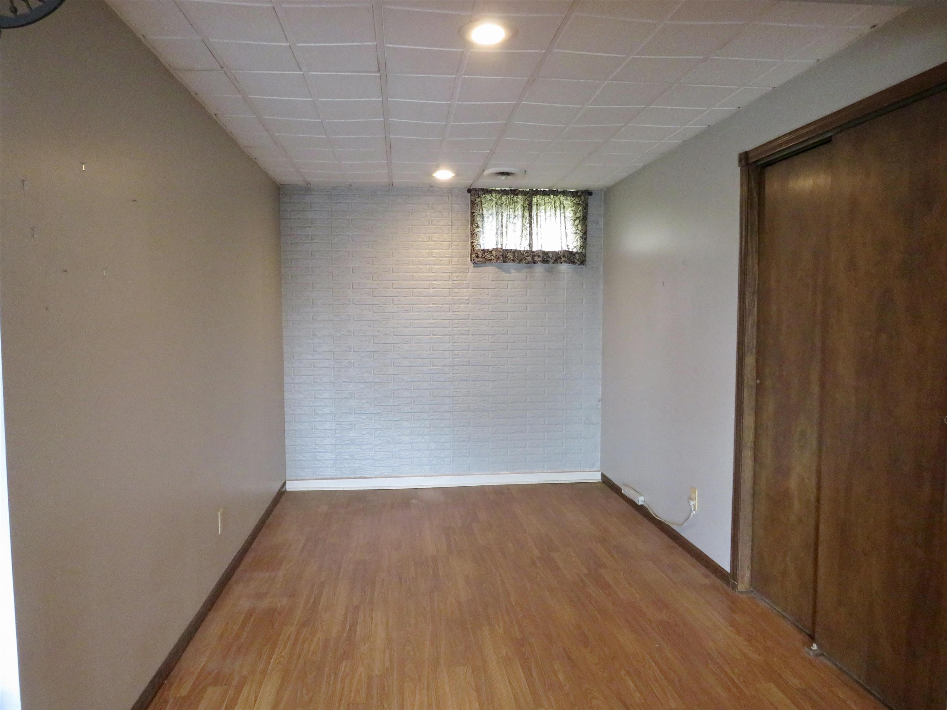 1139 Highway 20 Elizabeth, IL 61028 - Photo 32 of 88 a view of an empty room with wooden floor and a window