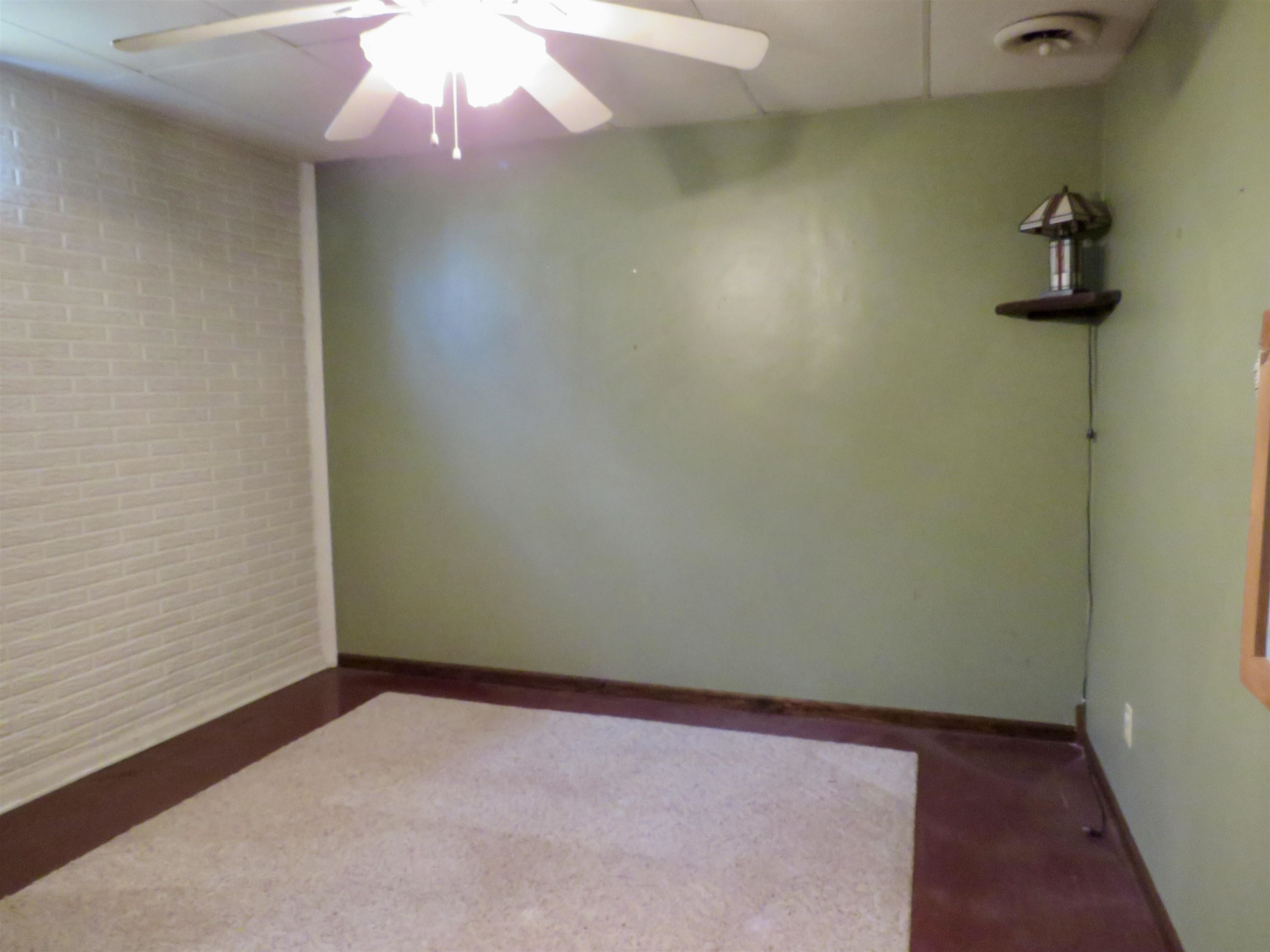 1139 Highway 20 Elizabeth, IL 61028 - Photo 33 of 88 an empty room with a ceiling fan and wooden floor
