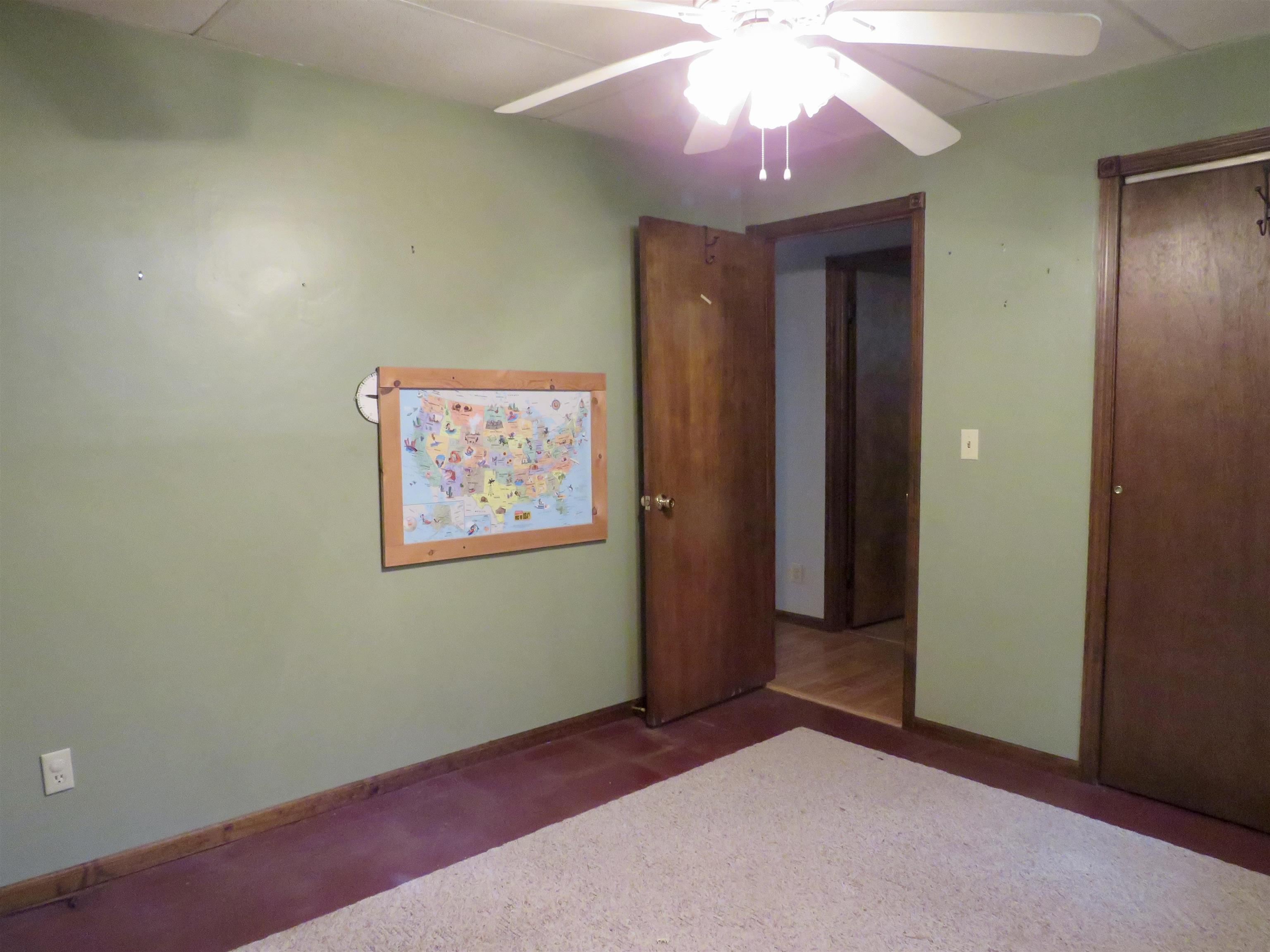1139 Highway 20 Elizabeth, IL 61028 - Photo 35 of 88 an empty room with a ceiling fan and window