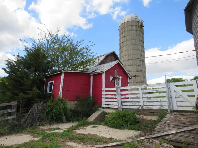a front view of a house with a garden and deck