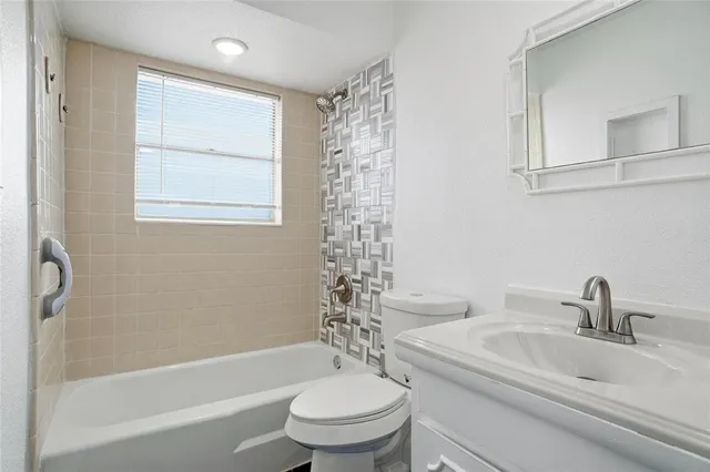 a bathroom with a sink a toilet and a bathtub