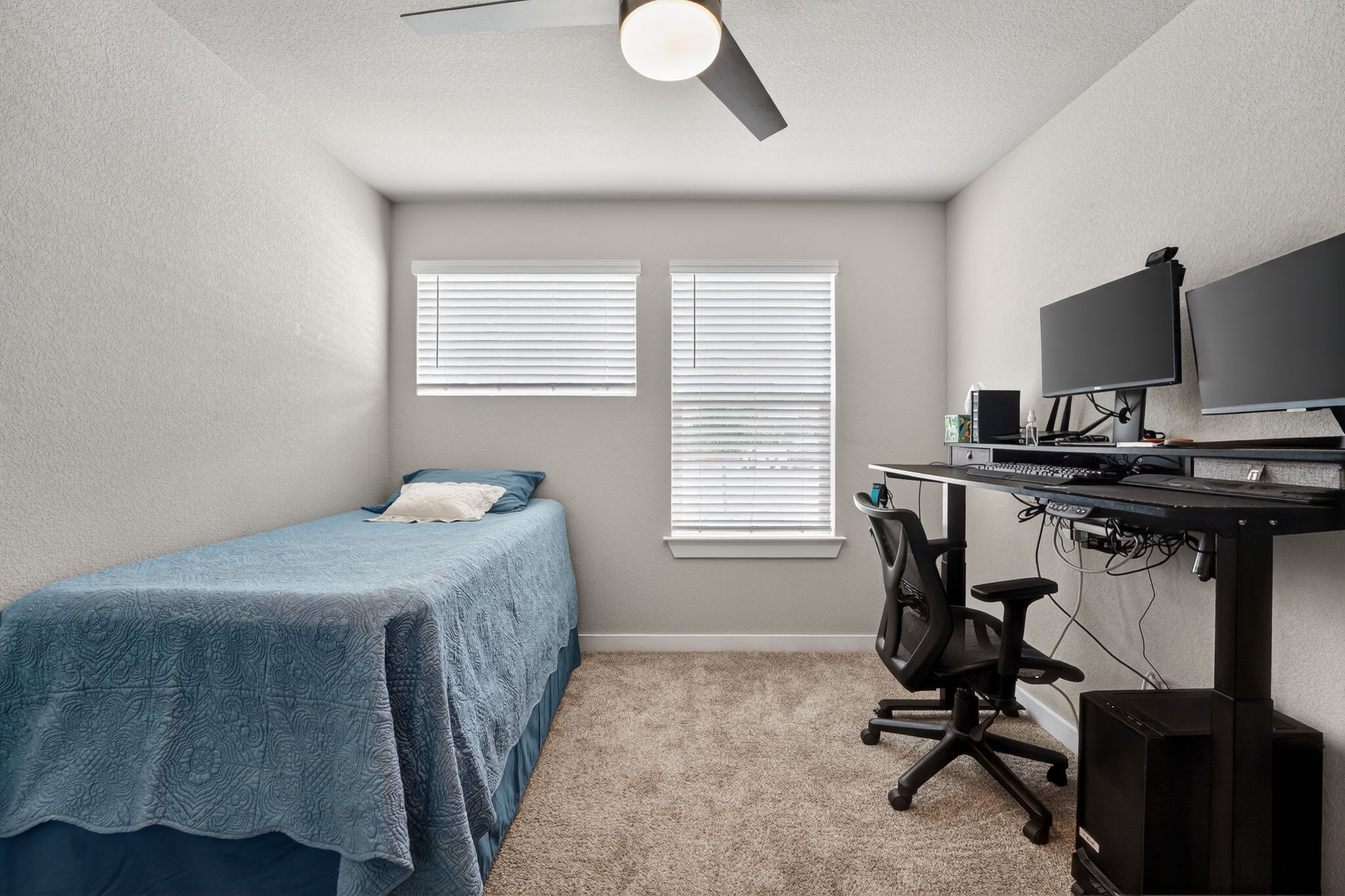 117 Halford Road Georgetown, TX 78633 - Photo 24 of 31 Bedroom featuring a textured wall, light colored carpet, an office area, and ceiling fan