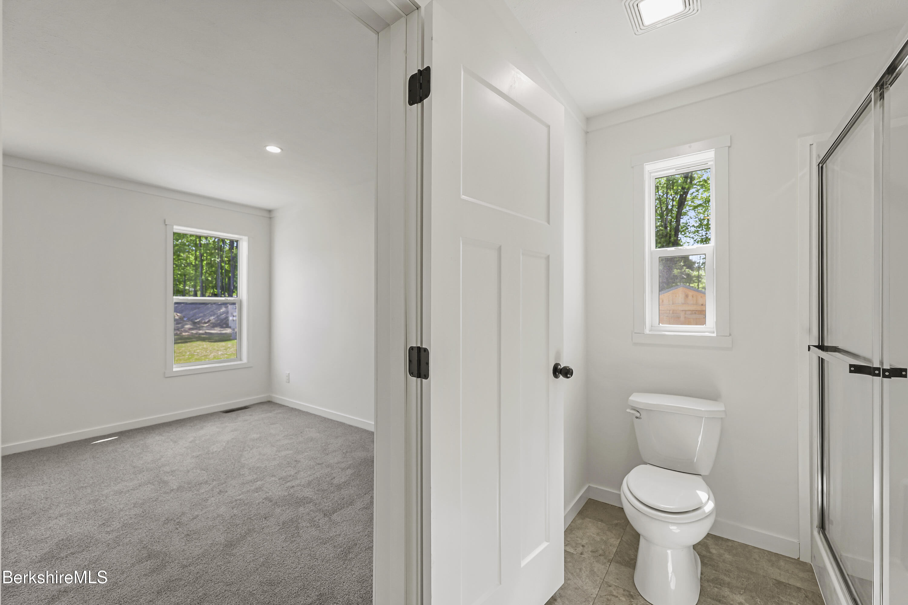 395 Cheshire Road, Unit 112 Pittsfield, MA 01201 - Photo 25 of 32 a bathroom with a toilet sink and window