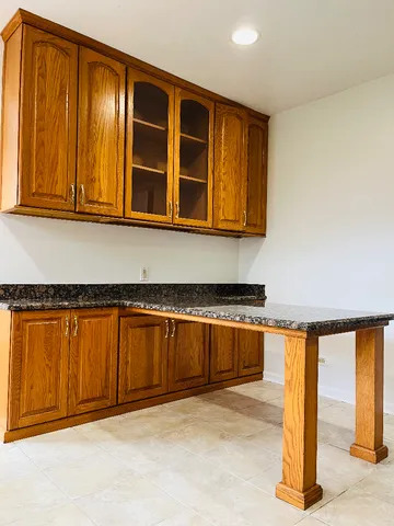 a view of a kitchen with wooden floor and a sink