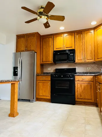 a kitchen with a stove a refrigerator and a sink