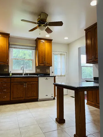 a kitchen with a sink window and cabinets
