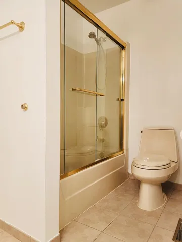 a bathroom with a toilet and shower