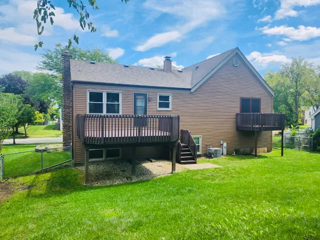 a front view of a house with a garden and yard