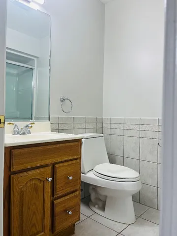 a bathroom with a toilet a sink and mirror
