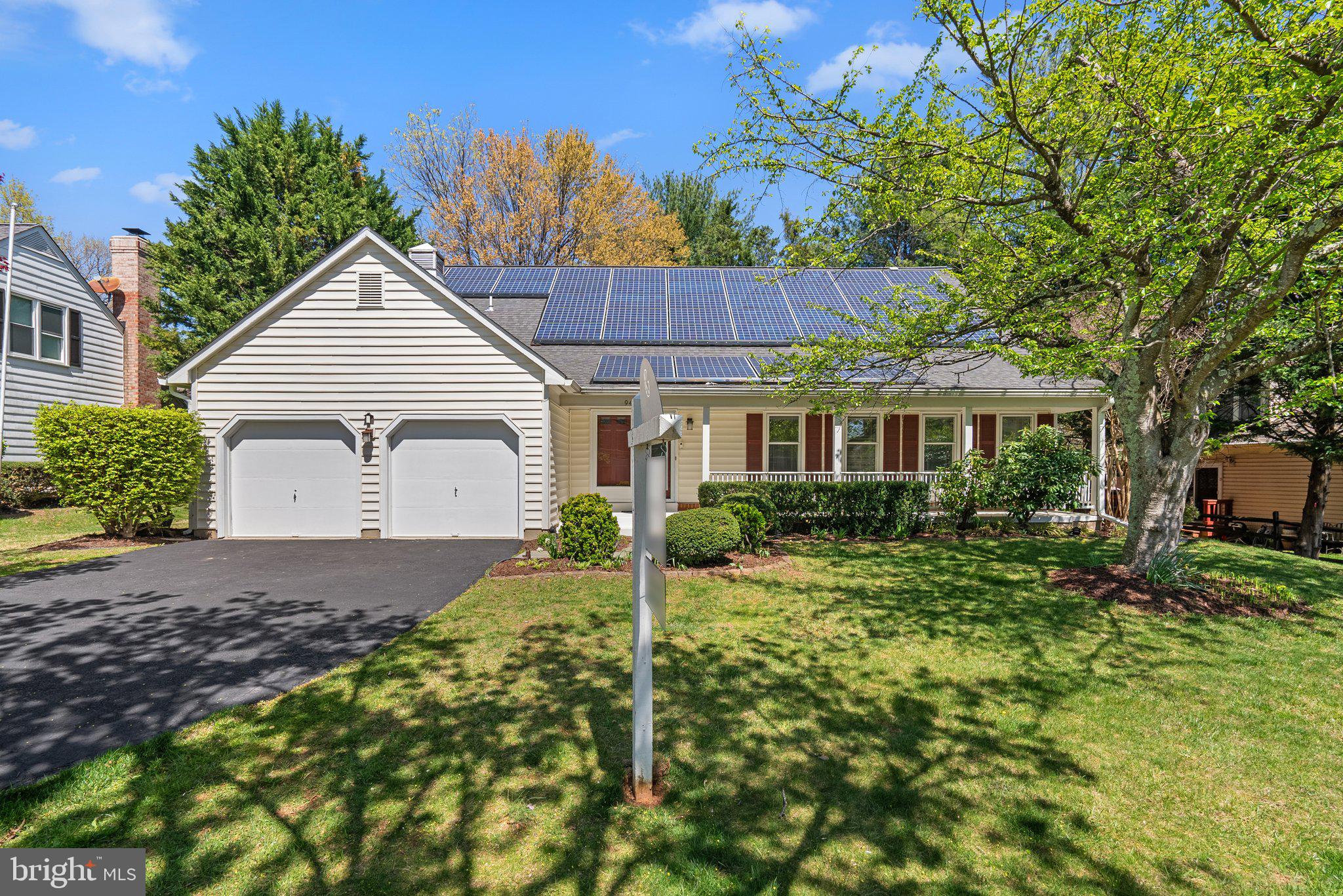 a view of a house with a yard and potted plants