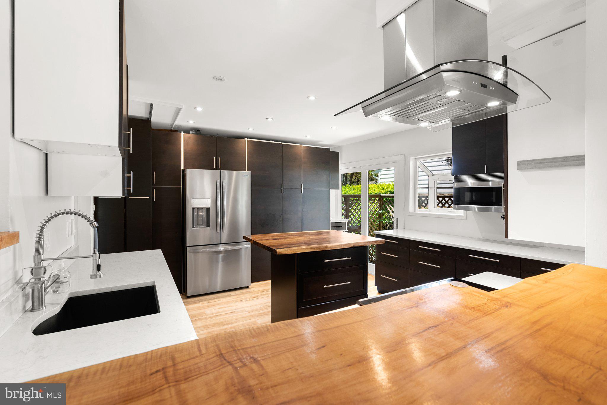 943 Willowleaf Way Potomac, MD 20854 - Photo 14 of 49 a kitchen with stainless steel appliances a sink stove and refrigerator