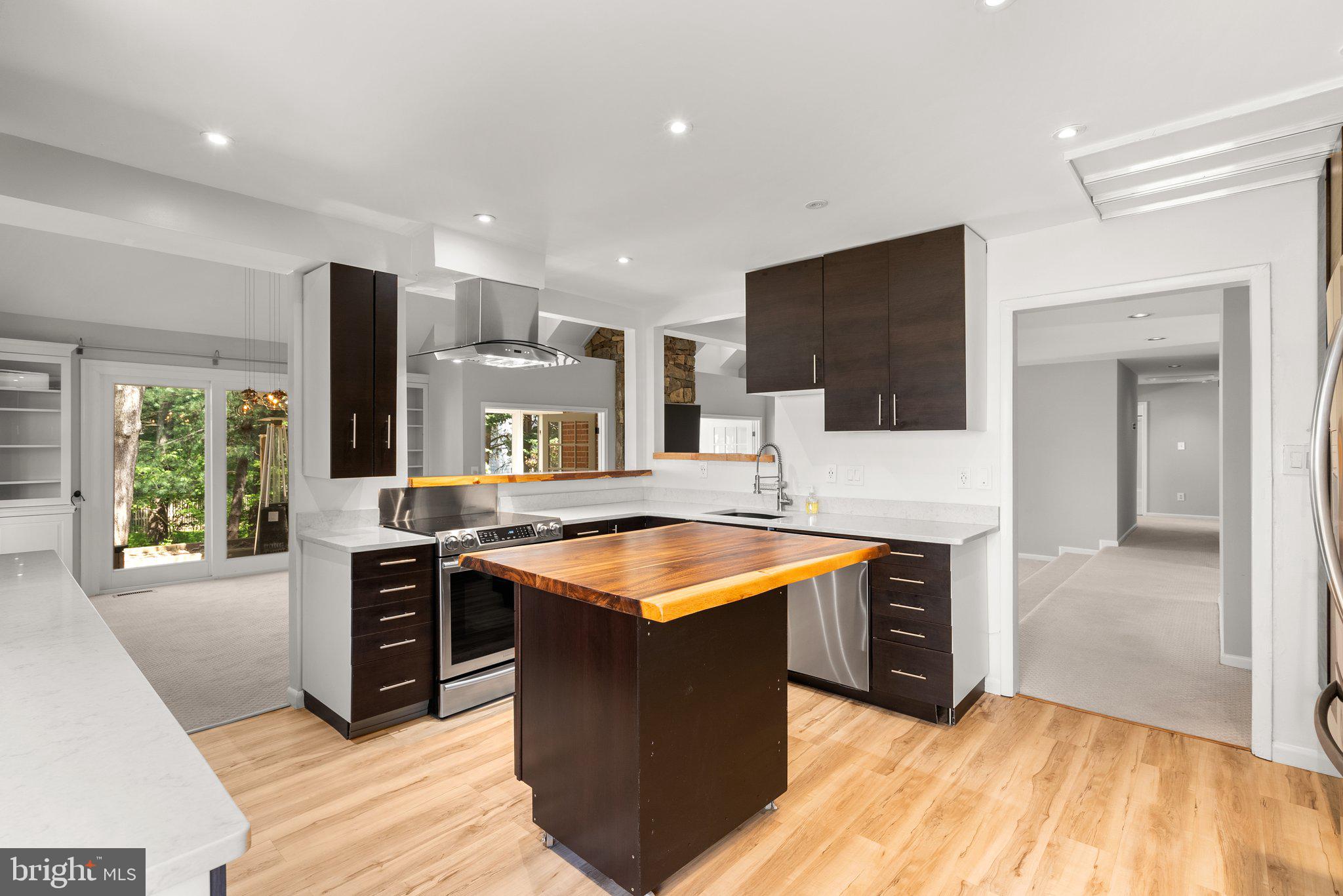 943 Willowleaf Way Potomac, MD 20854 - Photo 16 of 49 a kitchen with stainless steel appliances granite countertop a stove and a sink