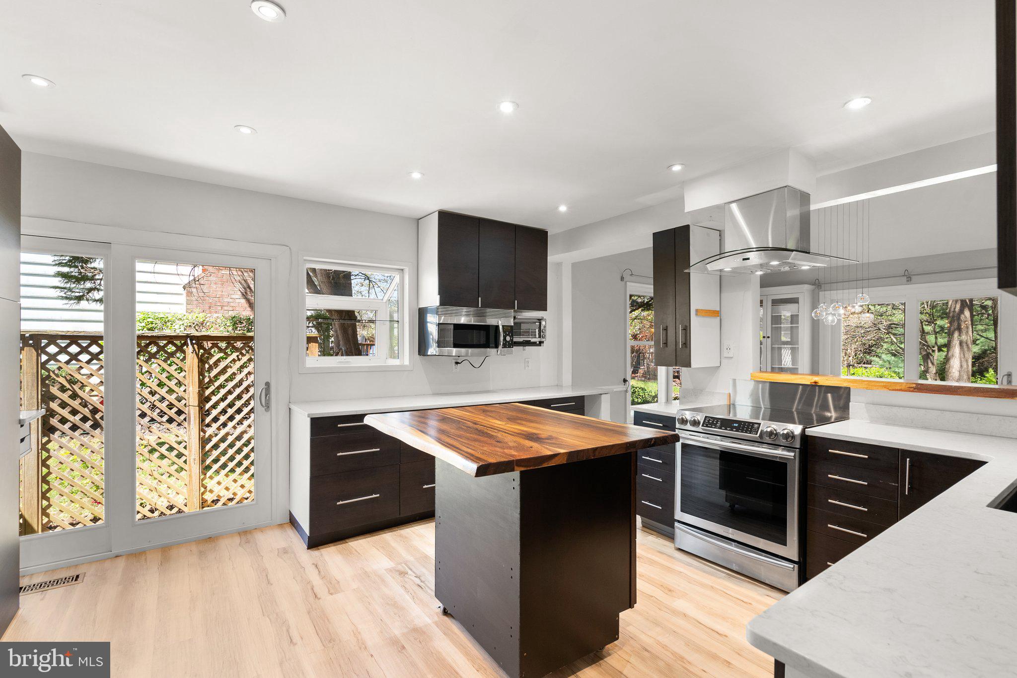 943 Willowleaf Way Potomac, MD 20854 - Photo 17 of 49 a kitchen with stainless steel appliances granite countertop a sink and a stove