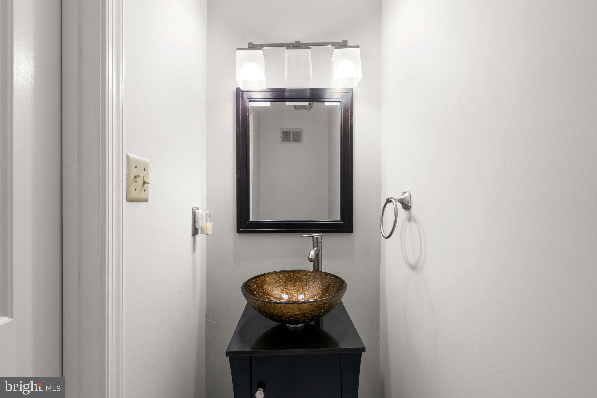 943 Willowleaf Way Potomac, MD 20854 - Photo 18 of 49 a bathroom with a sink and mirror