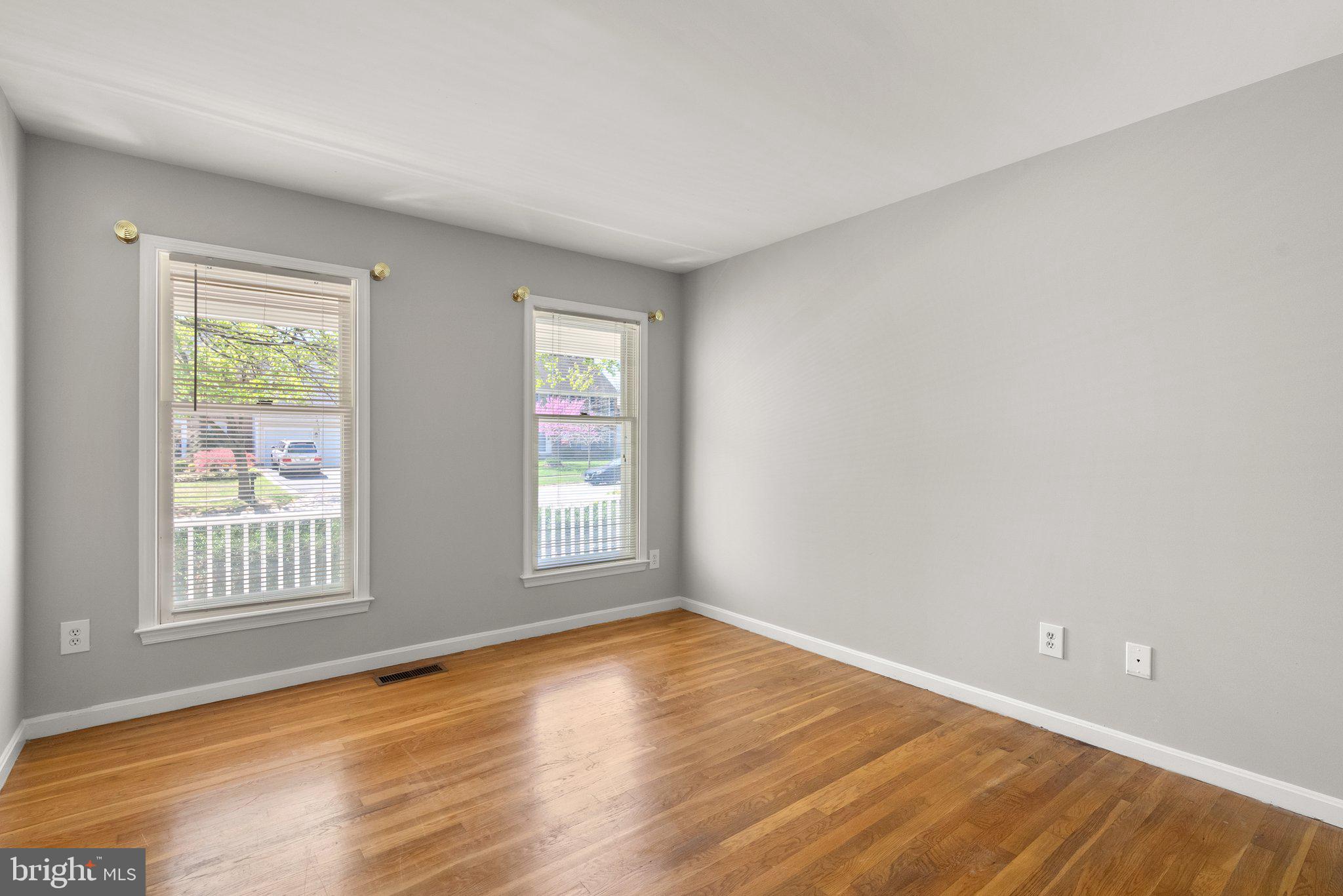 943 Willowleaf Way Potomac, MD 20854 - Photo 19 of 49 an empty room with wooden floor and windows