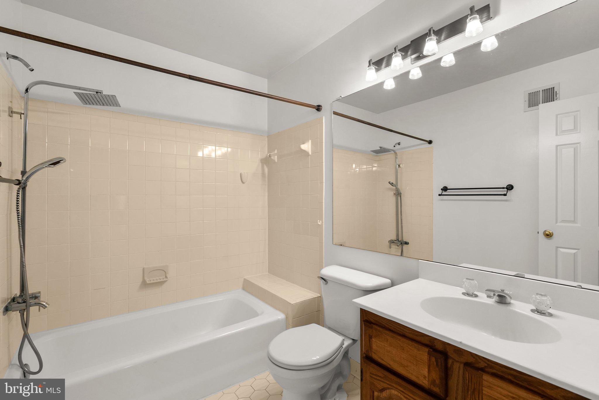 943 Willowleaf Way Potomac, MD 20854 - Photo 23 of 49 a bathroom with a sink a toilet and a large mirror