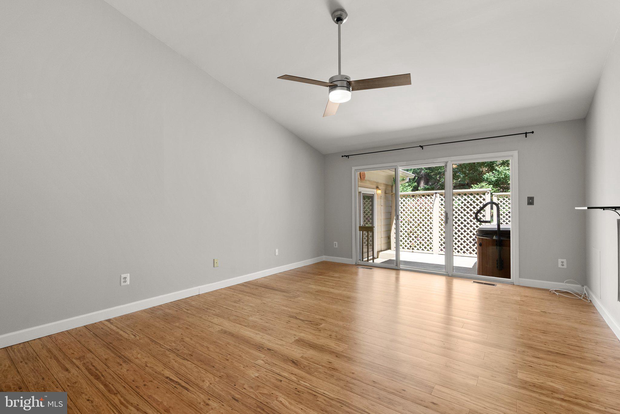 943 Willowleaf Way Potomac, MD 20854 - Photo 24 of 49 a view of an empty room with a window and wooden floor