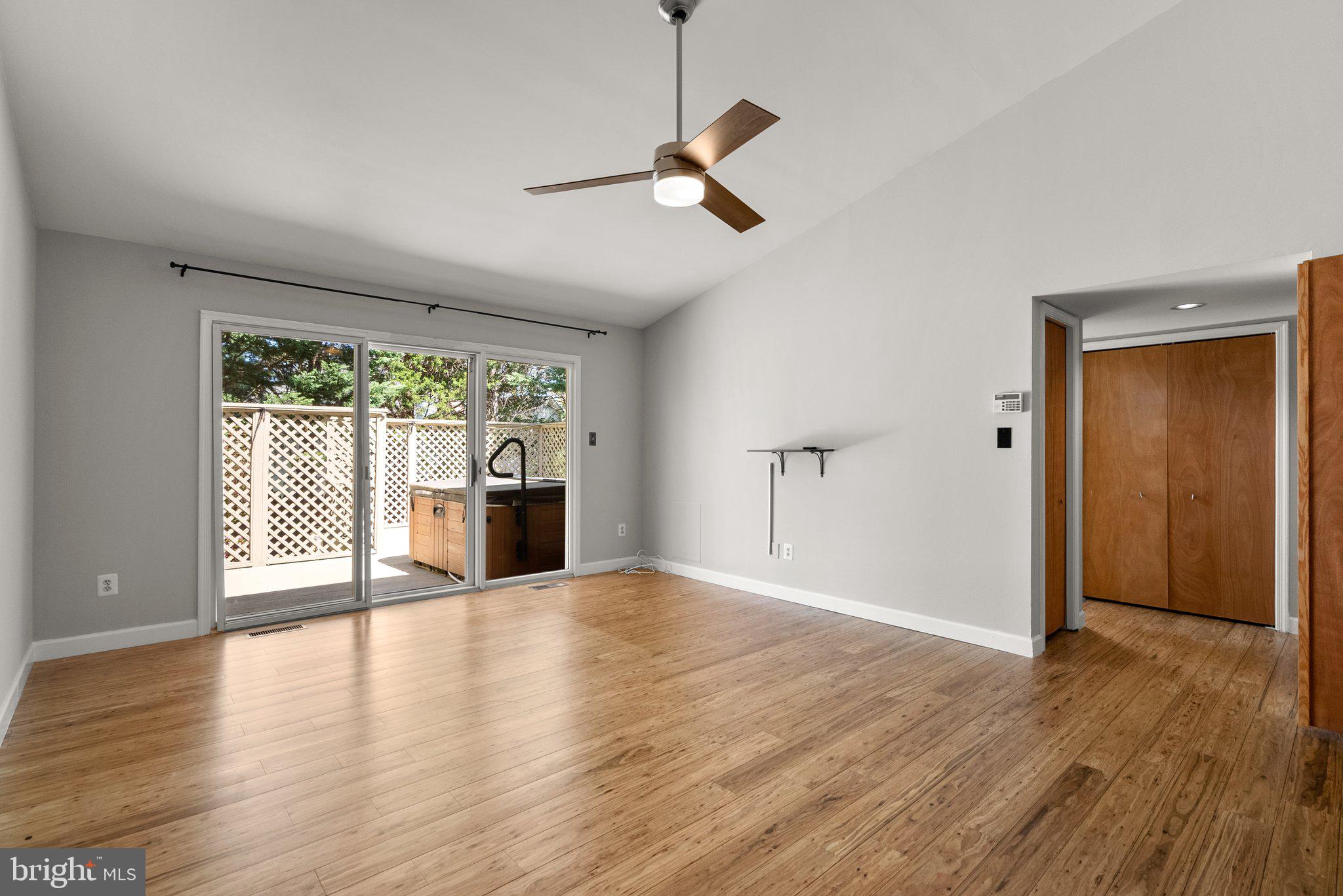 943 Willowleaf Way Potomac, MD 20854 - Photo 25 of 49 a view of a livingroom with wooden floor and a ceiling fan