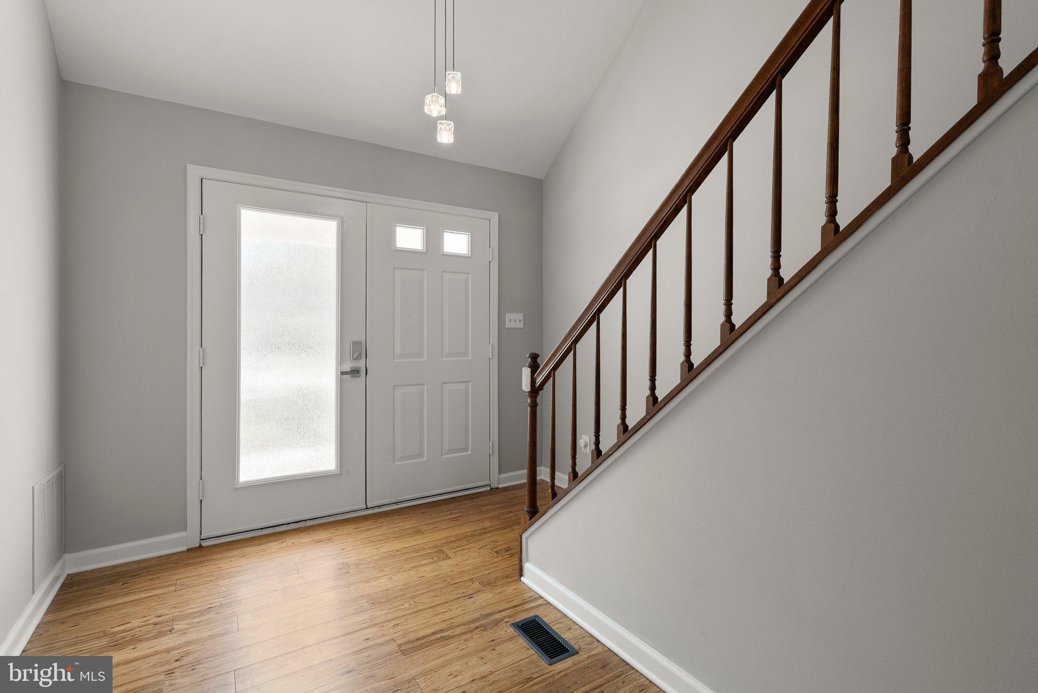 943 Willowleaf Way Potomac, MD 20854 - Photo 5 of 49 a view of a hallway with wooden floor and staircase