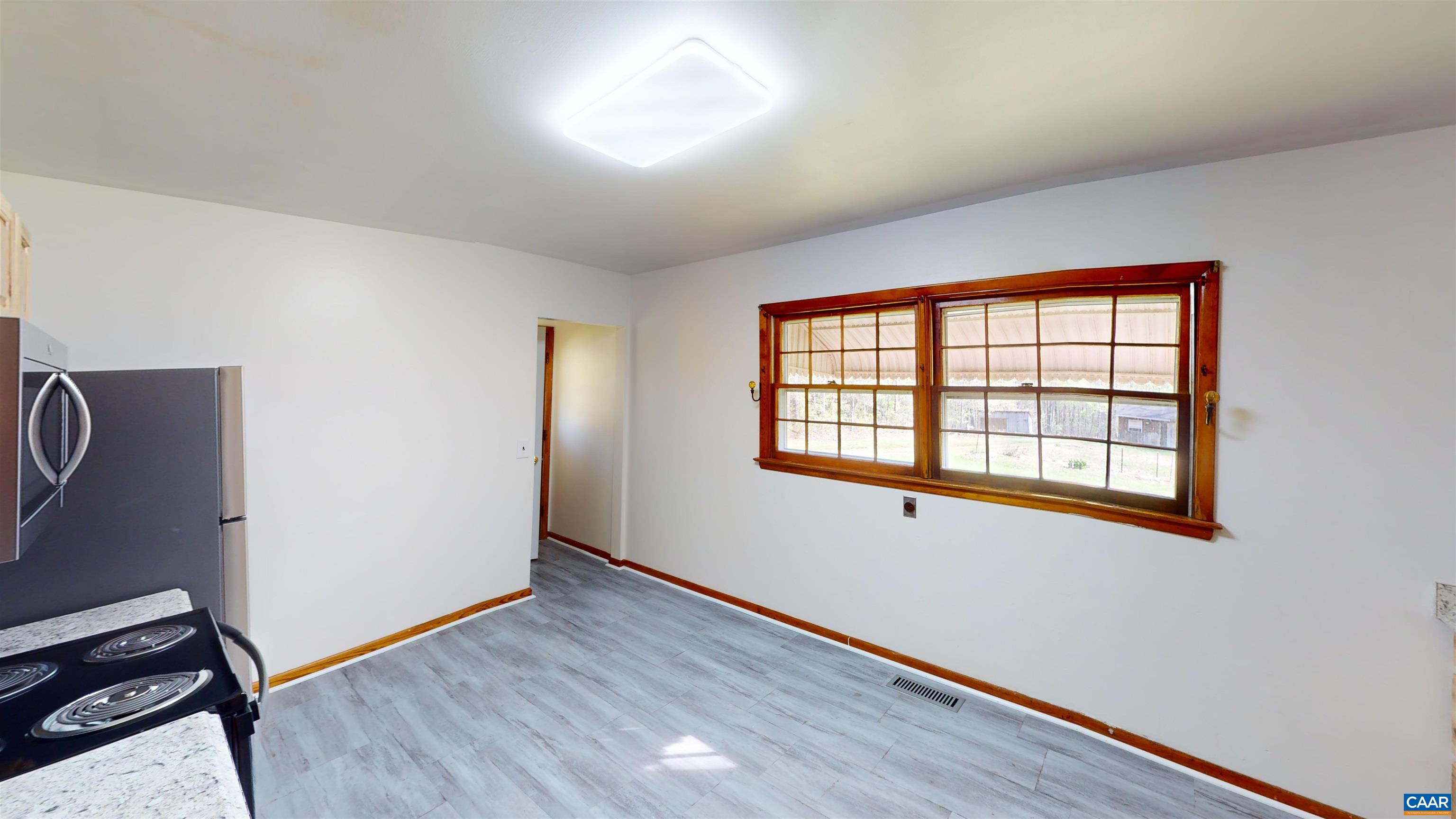 3595 Garth Road Charlottesville, VA 22901 - Photo 11 of 14 a view of an empty room with wooden floor and a window