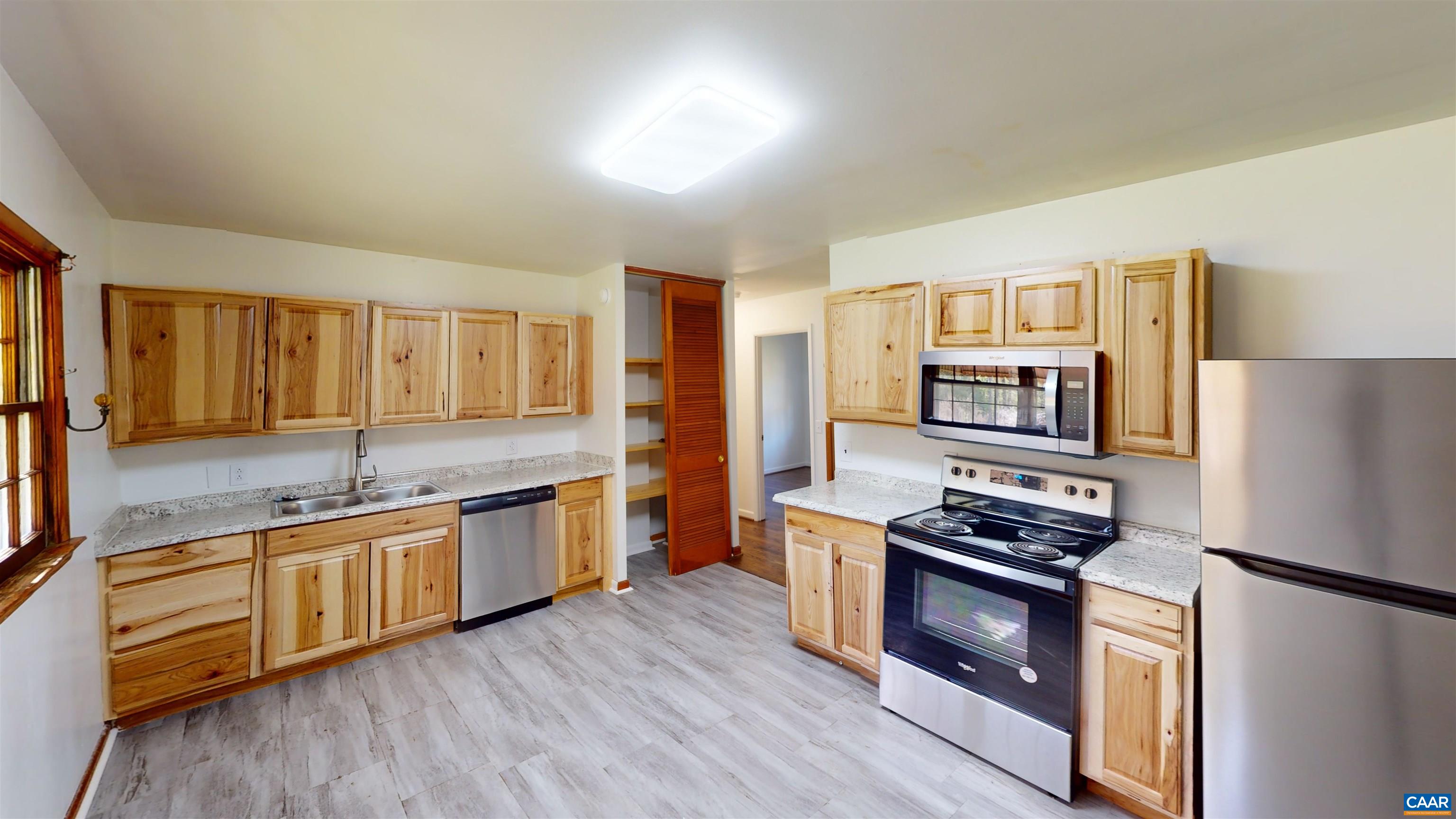 3595 Garth Road Charlottesville, VA 22901 - Photo 12 of 14 a kitchen with stainless steel appliances a stove a sink and a refrigerator
