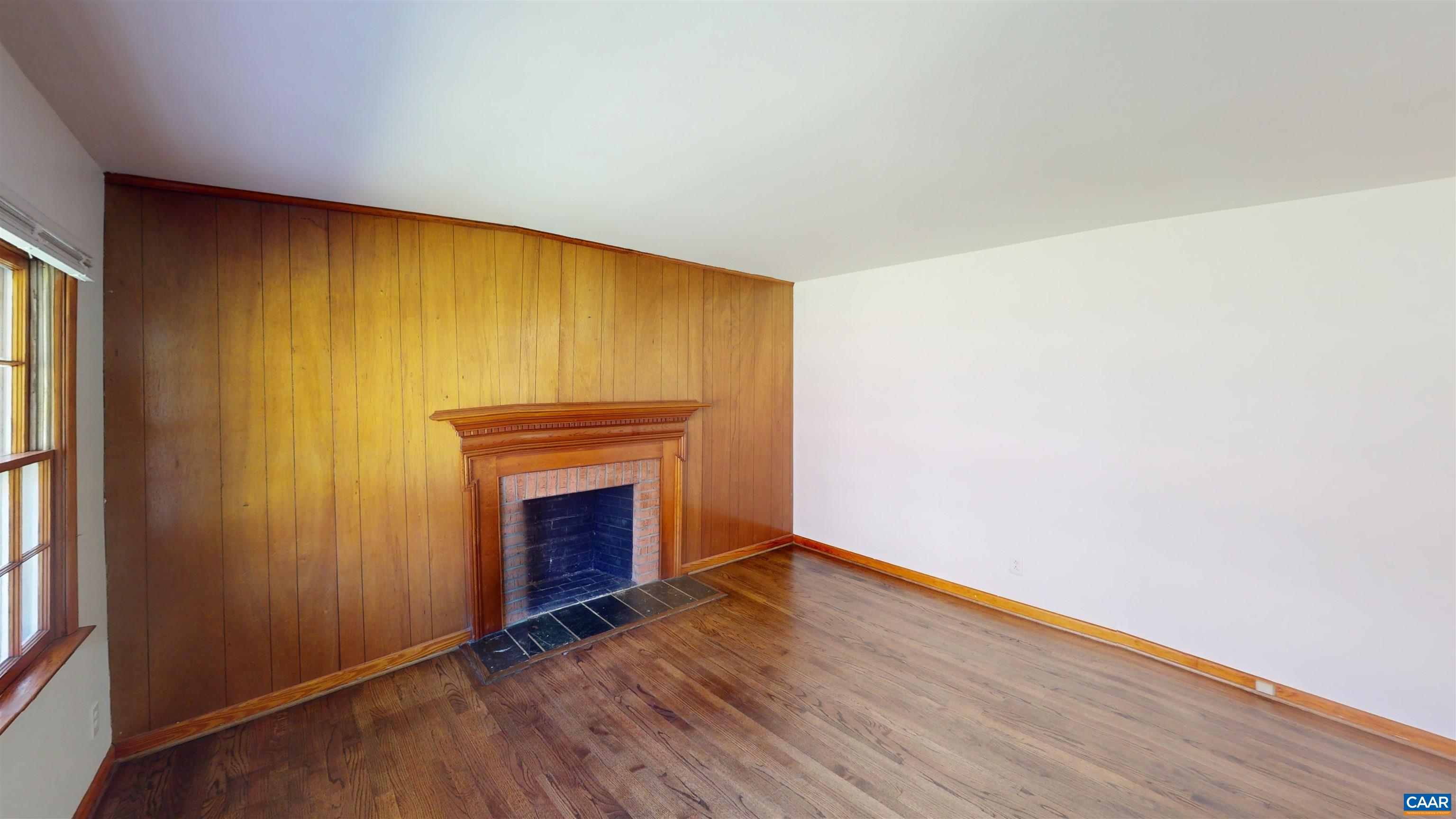 3595 Garth Road Charlottesville, VA 22901 - Photo 14 of 14 a view of empty room with wooden floor and fireplace
