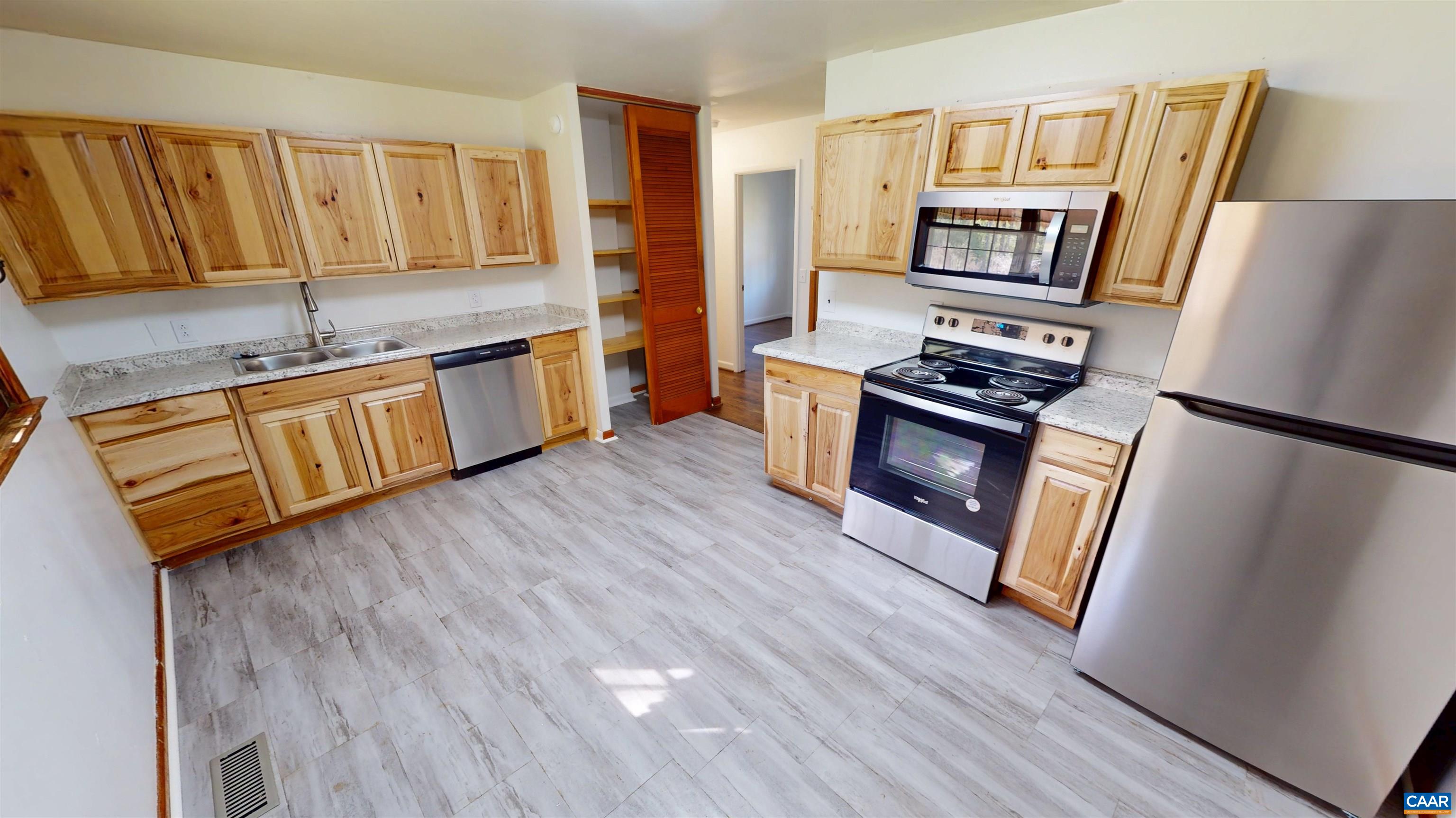 3595 Garth Road Charlottesville, VA 22901 - Photo 2 of 14 a kitchen with stainless steel appliances granite countertop a refrigerator a stove top oven and wooden floors