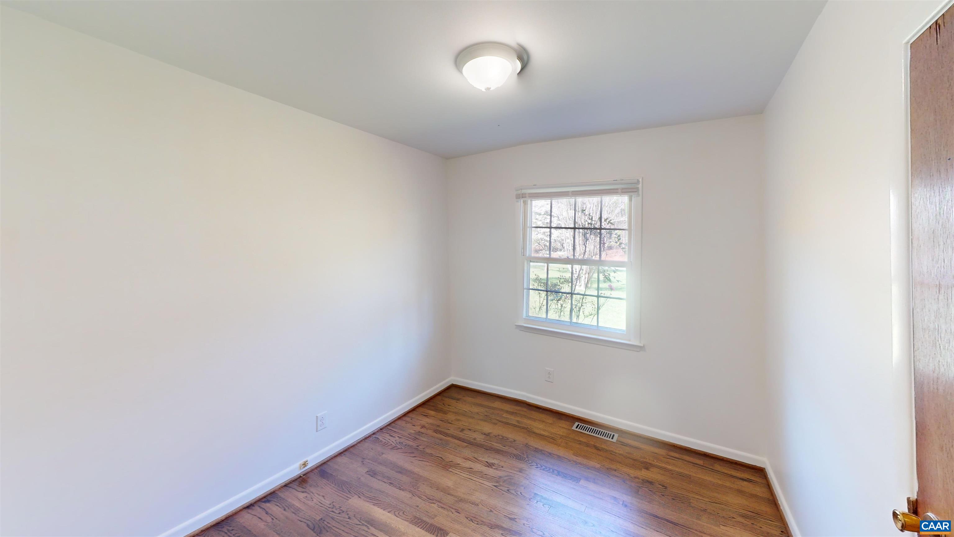 3595 Garth Road Charlottesville, VA 22901 - Photo 7 of 14 an empty room with wooden floor and windows